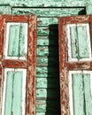 Rustic green and brown shutters expose chipped paint in the Ukrainian sun Royalty Free Stock Photo