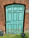 Rustic Green Door in Outside garden door. Calke Abbey, Derbyshire, UK. 2020.