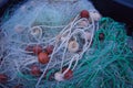 Rustic green fishing net with buoys and ropes Royalty Free Stock Photo