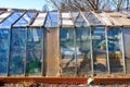 Rustic greenhouse with glass panels in rural setting on a sunny day Royalty Free Stock Photo