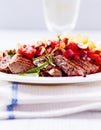Rustic grilled pork fillet with tomato salsa and french fries