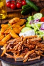Rustic gyros plate it green salad and potato wedges Royalty Free Stock Photo