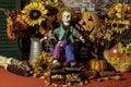 Rustic Halloween still life with clown doll and jack o lantern