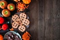 Rustic Halloween treat side border over a dark wood background Royalty Free Stock Photo