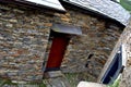 Rustic hand-hewn wood door set into a stone wall built from schist in PiodÃÂ£o, made of shale rocks stack, one of Portugal's schist