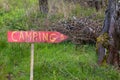 Rustic handcrafted camping sign on wooden plank arrow in nature Royalty Free Stock Photo