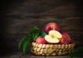 Rustic healthy red apples in a bascket on wooden background Royalty Free Stock Photo