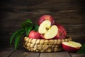 Rustic healthy red apples in a bascket on wooden background Royalty Free Stock Photo