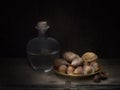 Rustic home made grappa with asorted nuts, still life light painting. Royalty Free Stock Photo