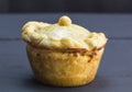 Single rustic home made pie close up with selective focus on black table Royalty Free Stock Photo