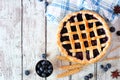 Rustic homemade blueberry pie. Above view table scene over a white wood background.