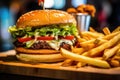 Rustic Homemade Cheeseburger and golden fries Royalty Free Stock Photo