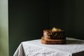 Rustic homemade chocolate cake on a wooden disc