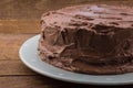 Rustic homemade whole chocolate cake on wood table Royalty Free Stock Photo