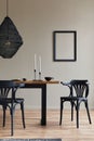 Rustic interior design of dining room with wooden family table, candelstick, retro chair, cup of coffee, decoration, mock up.