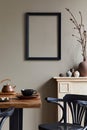 Rustic interior design of dining room with wooden family table, retro chair, cup of coffee, decoration, mock up frame.