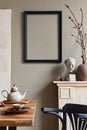 Rustic interior design of dining room with wooden family table, retro chair, cup of coffee, decoration, mock up frame.