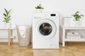 Rustic interior of home laundry room with modern washing machine Royalty Free Stock Photo