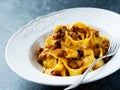 Rustic italian pappardelle bolognese pasta in meat sauce