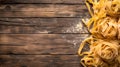 Rustic italian pasta on wooden background. homemade tagliatelle ready to cook. conceptual image of traditional cuisine Royalty Free Stock Photo