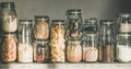 Rustic kitchen food storage arrangement in glass jars