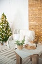 Rustic kitchen and living room interior decorated for Christmas. New Year`s interior of the Scandinavian style. Textural light roo Royalty Free Stock Photo