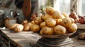 A rustic kitchen scene with a pile of fresh potatoes on a scale. Royalty Free Stock Photo