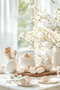 A rustic kitchen table is beautifully arranged with Easter egg dyeing supplies, eggs in various stages, and fresh Royalty Free Stock Photo