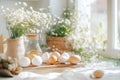A rustic kitchen table is set with Easter egg dyeing supplies, including pastel dyes, eggs, and delicate flowers. Soft Royalty Free Stock Photo