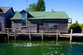 Rustic Lakeside Boathouse in Empire, Michigan Under Clear Blue Sky