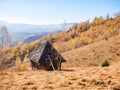 Rustic landscape with an abandoned old wooden house or shelter in the Carpathain Mountains, Romania. Autumn landscape Royalty Free Stock Photo