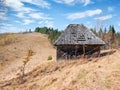 Rustic landscape with an abandoned old wooden house or shelter in the Carpathain Mountains, Romania. Autumn landscape Royalty Free Stock Photo