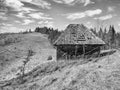 Rustic landscape with an abandoned old wooden house or shelter in the Carpathian Mountains, Romania. Autumn landscape Royalty Free Stock Photo