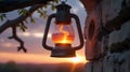 A rustic lantern hangs from the branches of an old tree, but instead of a candle inside, Royalty Free Stock Photo