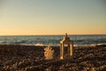 Rustic lattern and coral shaped candle on the pebble beach Royalty Free Stock Photo