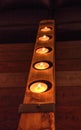 Rustic line of tea candles in wood Royalty Free Stock Photo