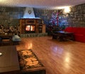 Rustic living room with fireplace and Christmas tree Royalty Free Stock Photo