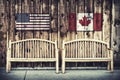 Rustic Log Benches with USA and Canada flag Royalty Free Stock Photo