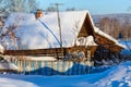 Rustic log house covered with snow. Village Visim, Sverdlovsk region, Russia.