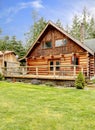 Rustic log small cabin deck exterior. Royalty Free Stock Photo