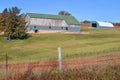 Rustic Barn with Green Roof and Blue Outbuilding Royalty Free Stock Photo