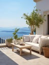 Rustic lounge sofa and coffee table on white stone terrace. Traditional Mediterranean architecture. Summer with sea view Royalty Free Stock Photo