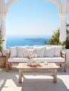 Rustic lounge sofa and coffee table on white stone terrace. Traditional Mediterranean architecture. Summer with sea view Royalty Free Stock Photo