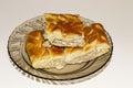 Rustic meat pie in a plate on a white table Royalty Free Stock Photo