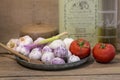 Rustic mediterranean cuisine still life with oil, tomatoes and garlic Royalty Free Stock Photo