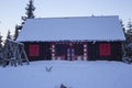 Rustic mountain cabin covered in snow