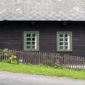 Rustic mountain cottage front in brown and green