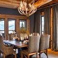 A rustic, mountain lodge-inspired dining room with log furnishings, antler chandeliers, and plaid textiles on chairs and curtain Royalty Free Stock Photo