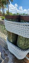 Rustic nautical rope fence and wrapped wooden dock posts. Vacation resort paradise.