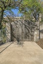 Rustic and old arched wooden gate at the entrance of a private property